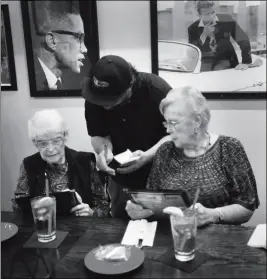  ?? YUMA SUN FILE PHOTO ?? WAITER GABRIEL URENA (CENTER) HELPS CUSTOMERS Vi Nidiffer (left) and Leone McAdams with their lunch time order at Da Boyz Pizza & Pasta, 284 S. Main St. State economists say that one of every eight news jobs in Arizona will be in preparing and serving...