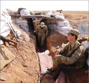  ??  ?? Syrian rebel-fighters from the National Liberation Front (NLF) man a position at the frontline facing regime areas in the southern countrysid­e of Aleppo, yesterday.