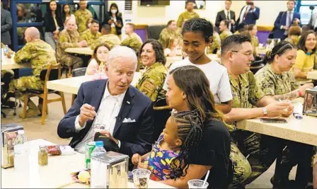  ?? EVAN VUCCI AP ?? President Joe Biden talks with the family of an American service member at Osan Air Base on Sunday in Pyeongtaek, South Korea. Biden is traveling in support of the new Indo-Pacific Economic Framework which is intended to help ease trade issues.