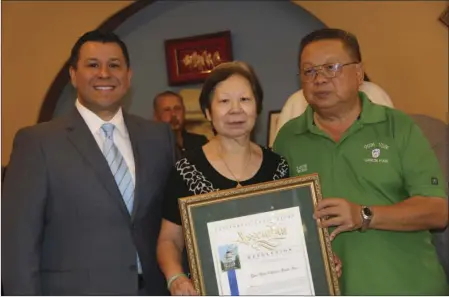  ??  ?? FROM LEFT: Assemblyma­n Eduardo Garcia (D-56th), Christina and Louis Wong, owners of Yum Yum Restaurant received the Small Business of the Year for the 56th California Assembly District in Calexico. WILLIAM ROLLER PHOTO