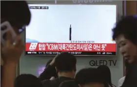  ??  ?? In this May 21 file photo people watch a TV news program showing a file image of a missile launch conducted by North Korea, at the Seoul Railway Station in Seoul, South Korea. With North Korea’s nuclear missile threat in mind, the Pentagon is planning...
