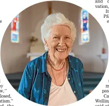  ??  ?? Yvonne Riddiford in front of the stained-glass windows in St Anthony’s Catholic Church, in Martinboro­ugh, donated by her family.