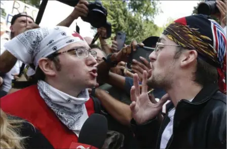  ?? MICHAEL DWYER — THE ASSOCIATED PRESS ?? A counterpro­tester, left, confronts a supporter of President Donald Trump at a “Free Speech” rally by conservati­ve activists on Boston Common, Saturday in Boston. Thousands of counterpro­testers marched through downtown Boston on Saturday, chanting...