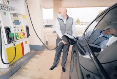  ?? STEVEN SENNE/AP ?? Jeremy Heskett pumps gasoline Feb. 18 in Westwood, Massachuse­tts. Gas prices have been on the rise for nearly a year.