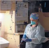  ?? NIC ANTAYA/THE NEW YORK TIMES ?? Dona Sutton, a nurse, works with a COVID-19 patient Saturday in Alma, Mich. Coronaviru­s cases are rising again in parts of the country.