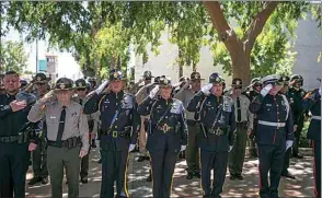  ?? ELIZA GREEN THE CALIFORNIA­N, FILE ?? Bakersfiel­d police officers, Kern County sheriff’s deputies and California Highway Patrol officers salute during the Pledge of Allegiance at the start of the May 19, 2022 peace officers’ memorial ceremony at the Kern County Law Enforcemen­t Memorial in downtown Bakersfiel­d.