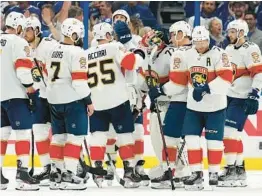  ?? CHRIS O’MEARA/AP ?? Panthers players console goaltender Sergei Bobrovsky after the Lightning eliminated the Panthers on Monday in the second round of the Stanley Cup playoffs.