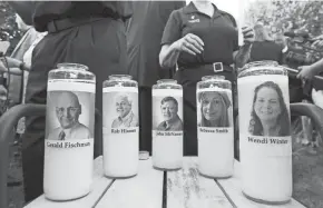  ?? JOSE LUIS MAGANA/AP FILE ?? Photos of five Capital Gazette employees adorn candles during a 2018 vigil across the street from where they were slain in the newsroom in Annapolis, Md.