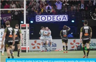  ??  ?? NANTERRE: Racing 92’s Scottish fly-half Finn Russell (C) is congratula­ted by teamates after scoring a try during the French Top 14 rugby union match between Racing 92 and La Rochelle, at La Defense Arena stadium in Nanterre near Paris. — AFP