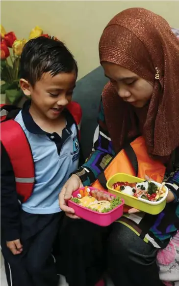  ??  ?? NANY menunjukka­n bento yang disediakan kepada anaknya, Khaleef Uwais.
Untuk vitamin saya selitkan daun salad, hirisan tomato dan timun manakala sumber kalsium menerusi susu kotak perisa asli sebagai pelengkap hidangan