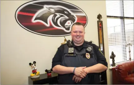  ?? MARK BUFFALO/THREE RIVERS EDITION ?? Sgt. John Dodd, school resource officer for the Cabot Public Schools, stands in the office of Freshman Academy principal Tanya Spillane. Dodd, who has been a police officer for 10 years, initiated the new Junior Police Academy program, which will take...