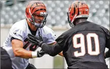  ?? NICK GRAHAM / STAFF ?? Bengals offensive tackle Jake Fisher (left) blocks defensive end Michael Johnson during practice Wednesday at Paul Brown Stadium in Cincinnati. He was medically cleared in February.