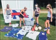  ?? Contribute­d photo ?? Nonnewaug girls soccer players sort and package uniforms, cones and balls to be sent to South Africa.