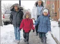  ?? JIM DAY/THE GUARDIAN ?? Amjad Al Rashdan leaves the P.E.I. Associatio­n for Newcomers to Canada in Charlottet­own with his children Basel, left, Idress, middle, and Shatha (missing from the photo is the children's mother Ghouson).