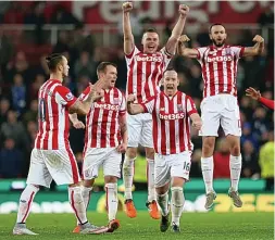  ?? REUTERS ?? Potters go potty: Charlie Adam (second right) leads the celebratio­ns after Stoke’s dramatic victory on penalties