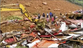  ?? SOCIETY 4 CLIMATE CHANGE COMMUNICAT­ION VIA ASSOCIATED PRESS ?? People survey the damage Monday after mudslides in Regent, east of Freetown, Sierra Leone. The mudslides came after heavy rains and flooding that killed scores of people near Sierra Leone’s capital.