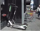  ?? JUSTIN SULLIVAN/GETTY IMAGES ?? Bird and Lime scooters sit parked in front of a building in San Francisco.