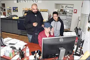  ?? NICK SMIRNOFF / FOR TEHACHAPI NEWS ?? South Street Digital offers full digital correction­s. Looking over a digitally corrected image prior to printing are Eric Horn, with co-owner Lydia Chaney standing, and fellow owner Audrey Post at the computer.