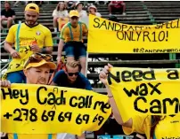  ?? AFP ?? Steve Smith may have garnered a wave of sympathy following his emotional press conference, but the South African fans were not in forgiving mood as they held banners to mock the Australian players during day one of the fourth Test on Friday. —