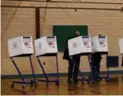  ?? JEWEL SAMAD/AFP/GETTY IMAGES ?? People cast their votes at a polling station in New York in 2016.