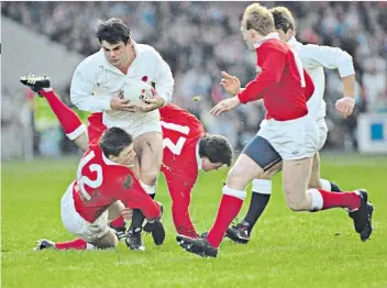  ??  ?? Brute force: Will Carling is halted by Scott Gibbs (right), while Paul Ackford and Wade Dooley (below) challenge for a line-out