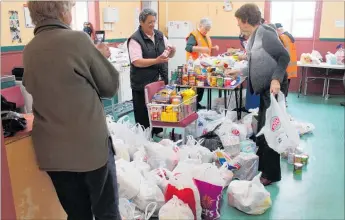  ??  ?? SOME of the food donated during the last food drive in November 2015 is sorted.