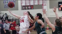  ?? MIKE BUSH/NEWS-SENTINEL ?? Lodi forward Ellie Van Tassel, 24, keeps the basketball in front of her and Tracy guard Brandy Robles, 23, in Thursday's TCAL opener at The Inferno.