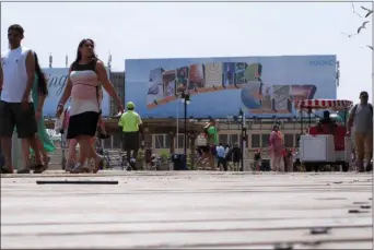  ?? WAYNE PARRY — THE ASSOCIATED PRESS ?? This photo shows people walking on the Boardwalk in Atlantic City N.J. Top executives of most of Atlantic City’s casinos on Thursday say the city needs to become cleaner and safer, with a better public perception in order for business conditions to truly improve.