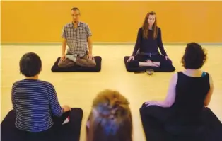  ?? STAFF FILE PHOTO ?? Yong Oh, left, and Janka Livoncova lead a meditation class at Clearsprin­g Yoga in 2016. Meditation is an important activity in Buddhism that helps to promote behaviors central to its teachings.