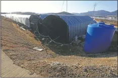  ??  ?? This photo shows dormitorie­s draped with black sunblock nets for migrant workers.