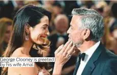  ??  ?? George Clooney is greeted by his wife Amal.