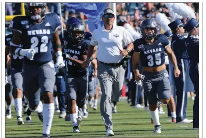  ?? (AP/Lance Iversen) ?? Nevada football Coach Jay Norvell (center) is familiar with Arkansas men’s basketball Coach Eric Musselman from Musselman’s time with the Wolf Pack. Now Norvell will get to know Arkansas football Coach Sam Pittman a little better when the schools square off Sept. 5 at Reynolds Razorback Stadium in Fayettevil­le.