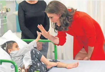  ?? Pictures: PA. ?? Above left: The Duchess of Cambridge received a number of gifts. Top: Major Tim Peake presented the Queen with the Union Jack from his spacesuit. Above right: Her majesty also received glitter balls for her Christmas tree.