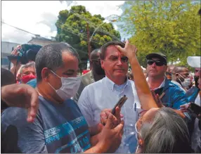  ?? Photo: Nampa/AFP ?? Cheered… A supporter touches the forehead of Brazilian President Jair Bolsonaro (centre) after he voted during the second round of municipal elections at the Rosa da Fonseca Municipal School, in the Military Village, Rio de Janeiro.