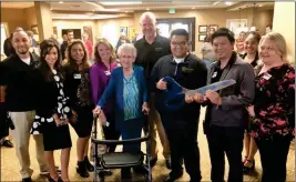  ?? LOANED PHOTO ?? RIVER VALLEY ESTATES, a senior living and memory care community in Yuma, welcomes new residents with a ribbon-cutting ceremony. Pictured are resident Shirley Lewis (center) and team members, Mission Senior Living President Darryl Fisher (back row),...
