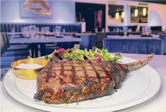  ?? Photos by Mike Sutter/Staff ?? The 44-ounce tomahawk rib-eye comes with frisee salad and a salt cellar at The Ace of Steaks, a steakhouse in Stone Oak in San Antonio.