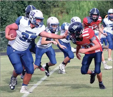  ??  ?? Heritage’s Anderson Britton gets a stiff-arm from Rossville running back Gordon Casteel last Thursday in Boynton. The Bulldogs stopped a late 2-point conversion attempt by the Generals and picked up a 14-12 victory in the NGAC opener for both teams....