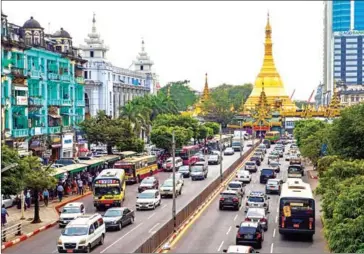  ?? AFP ROMEO GACAD/ ?? Traffic is seen on Mahabandoo­la Road, with Sule pagoda in the background, in central Yangon.