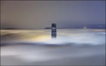  ?? @JOECHENPHO­TOGRAPHY / INSTAGRAM ?? A photograph­er on Victoria Peak catches the 484-meter Internatio­nal Commerce Centre in West Kowloon, Hong Kong’s tallest building, punching through a sea of glowing clouds.