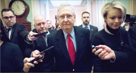  ??  ?? Telling reporters “we have the votes,” Senate Majority Leader Mitch McConnell, R- Ky., leaves a closed- door meeting with Republican lawmakers Friday.