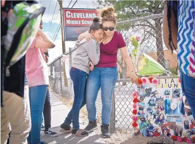  ?? MARLA BROSE/ JOURNAL ?? Rebecca Estrada, right, comforts her daughter Hailie, 12, who was best friends with Eliza Almuina and was crossing the street with her when she was struck and killed by an SUV on Thursday.