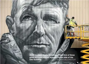  ?? MURRAY WILSON/STUFF ?? Artist Graham Hoete finishing off the first of three giant portraits of Kiwi legends on the side of the Obo building.