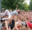  ?? ASSOCIATED PRESS ?? Oliver Feighan, one of the two members of the Philadelph­ia Rap group OCD, crowd surfs in this file photo from a previous Made In America concert on the Benjamin Franklin Parkway in Philadelph­ia.