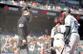  ?? Ezra Shaw / Getty Images ?? Rockies outfielder Charlie Blackmon argues with home plate umpire Ben May after striking out in the seventh inning against the Giants on Friday at Oracle Park in San Francisco.