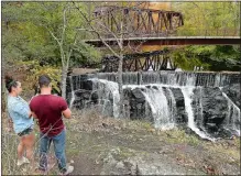  ?? SEAN D. ELLIOT/THE DAY ?? Aguinaldo Duarte and his wife, Maria Fernandes, of Brockton, Mass., take photos of Yantic Falls on Friday. Duarte and Fernandes were in the area to celebrate his birthday at Foxwoods Resort Casino and decided to find a scenic spot. Duarte used to work as a tour guide in the Boston area and likes to find interestin­g sites to visit.