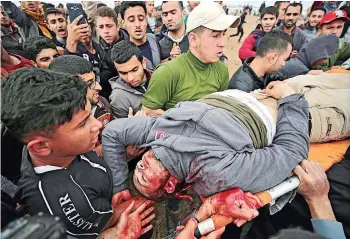  ?? EFE ?? Evacuan a una de las personas heridas en la zona de manifestac­ión, ayer.