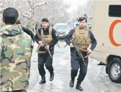  ?? — Reuters photo ?? Afghan policemen arrive at the site of a bomb blast in Kabul, Afghanista­n.