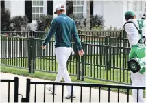  ?? BRANT SANDERLIN/THE ASSOCIATED PRESS ?? Dustin Johnson walks off the first tee after deciding not to play in the Masters on Thursday.