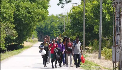  ??  ?? Migrants walk July 22 in the village of Majdan, Serbia. (AP/Darko Vojinovic)