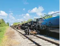  ?? STEVE LITSCHAUER/MANATEE COUNTY GOVERNMENT ?? Officials are keeping an eye on a train car carrying 30,000 gallons of propane that tipped over in a derailment in an industrial area near Sarasota Bradenton Internatio­nal Airport.